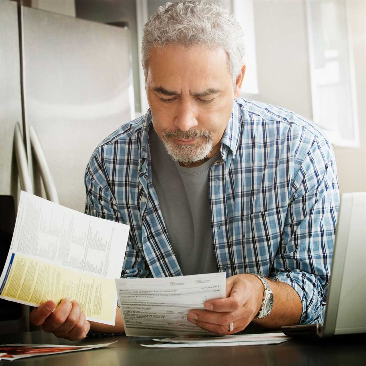 man looking at air conditioning bill