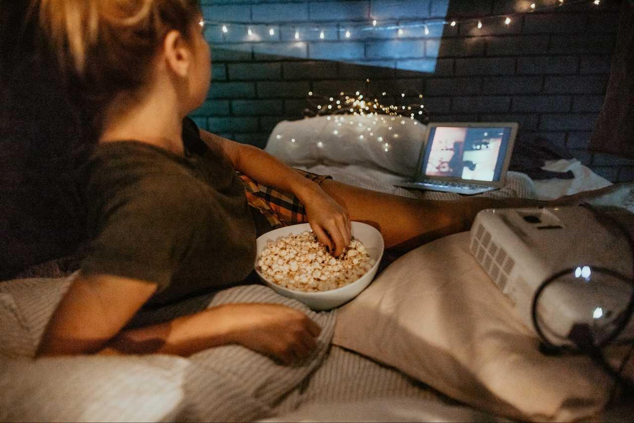 Young Woman Watching Movies In Home Theater