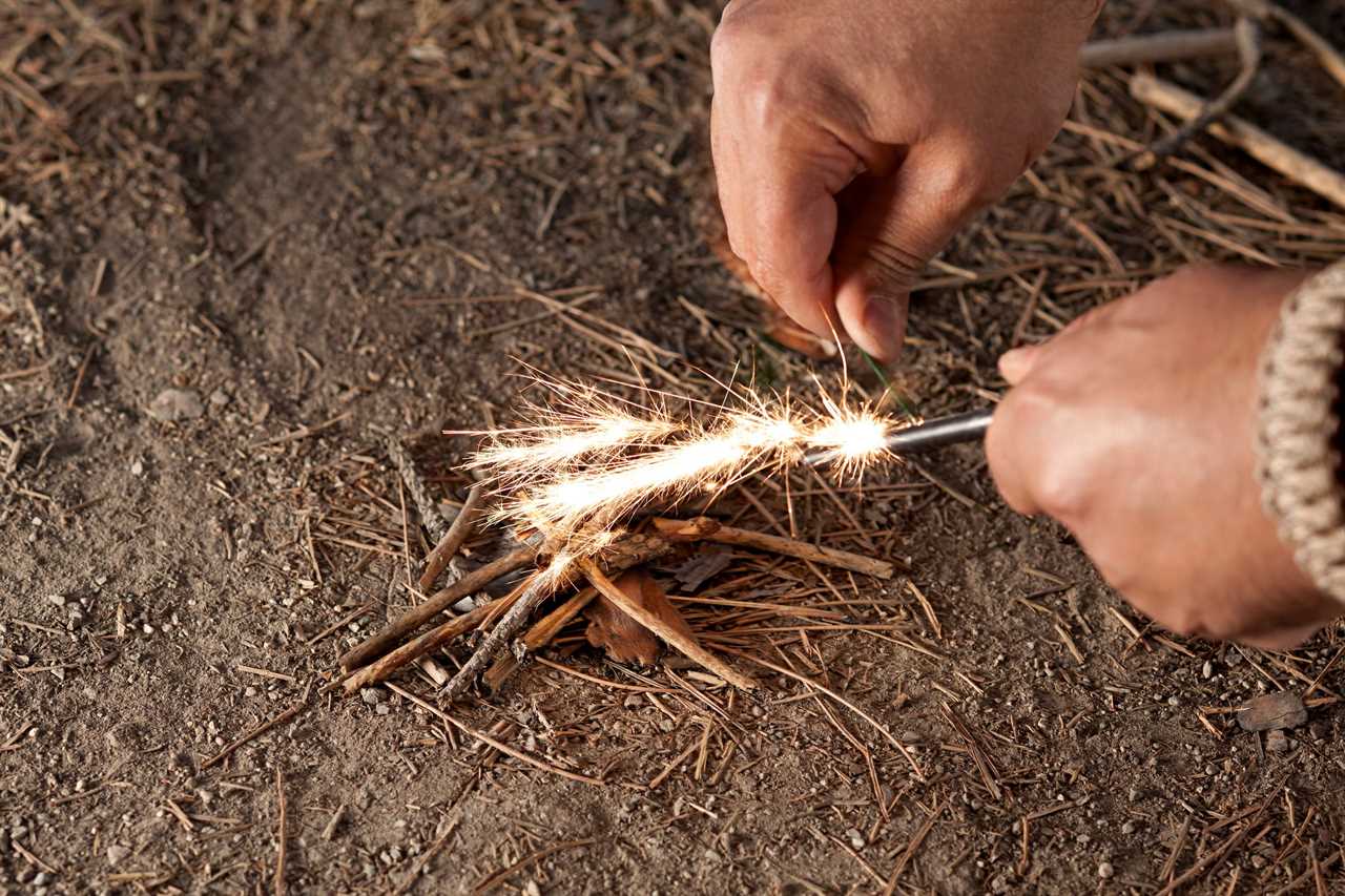 man starting a fire with flint